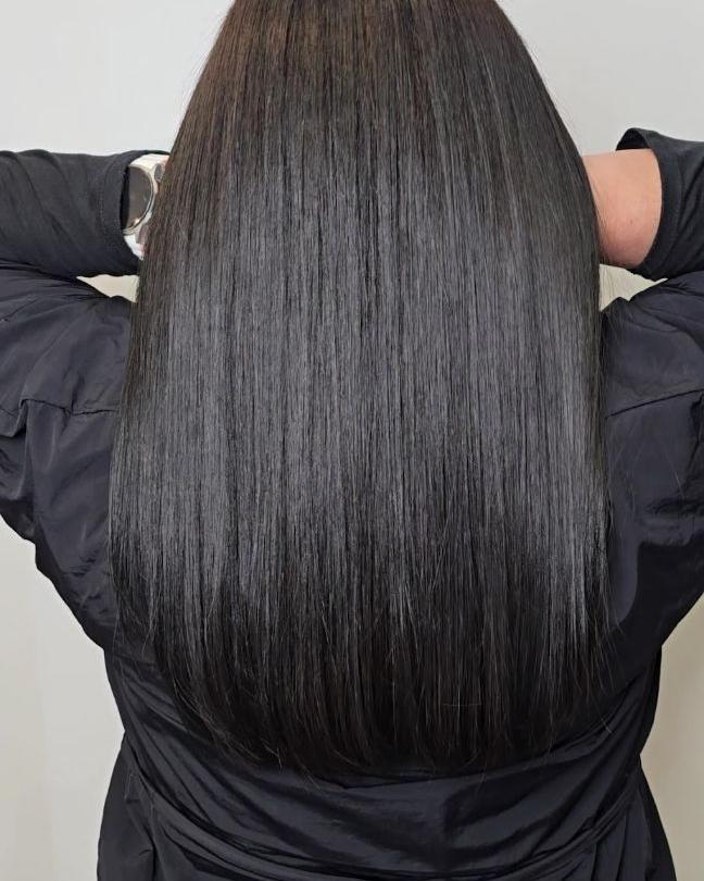 Long smooth dark hair finished at the salon